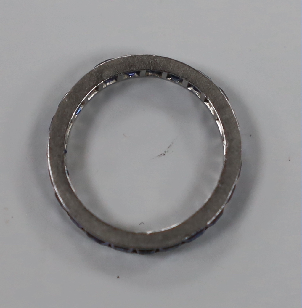 A white metal and sapphire set full eternity ring, size K, gross weight 2.6 grams.